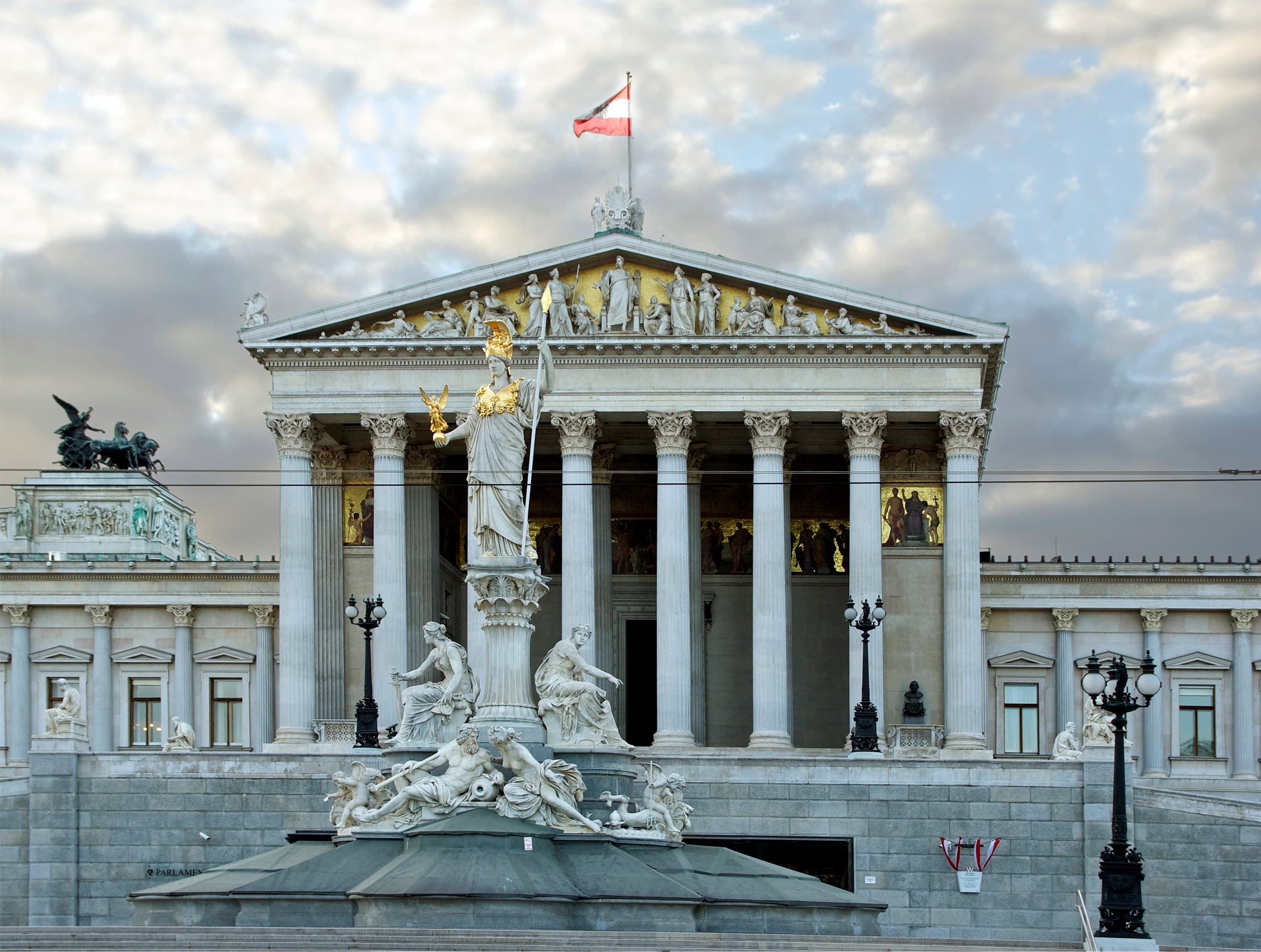 Austrian Parliament in Vienna with the Pallas Athena fountain and Austrian flag.